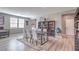 Bright dining area showcasing a table, chairs, bookshelves, and ample natural light from nearby windows at 6904 Baylor Creek St, North Las Vegas, NV 89086