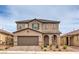 Inviting two-story home with a well-maintained front yard, covered entry, and an attached two-car garage at 6904 Baylor Creek St, North Las Vegas, NV 89086