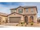 Inviting two-story home with a well-maintained front yard, covered entry, and an attached two-car garage at 6904 Baylor Creek St, North Las Vegas, NV 89086