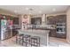 Bright kitchen with stainless steel appliances, dark cabinets, granite countertops, and a center island with seating at 6904 Baylor Creek St, North Las Vegas, NV 89086