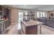 Well-equipped kitchen featuring stainless steel appliances, dark cabinets, center island, and seamless connection to the living area at 6904 Baylor Creek St, North Las Vegas, NV 89086
