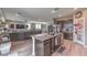 Open-concept kitchen showcasing a center island with seating, stainless steel appliances and seamless connection to the living area at 6904 Baylor Creek St, North Las Vegas, NV 89086