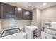 This functional laundry room features a washer, dryer, and ample storage cabinets at 6904 Baylor Creek St, North Las Vegas, NV 89086
