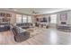 Comfortable living room with a large sectional sofa, entertainment center, and plenty of natural light at 6904 Baylor Creek St, North Las Vegas, NV 89086