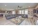 Inviting living space with a large sectional, open to the kitchen, and lots of windows at 6904 Baylor Creek St, North Las Vegas, NV 89086
