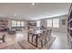 Spacious living area featuring a dining table, a large sectional sofa, and a ceiling fan at 6904 Baylor Creek St, North Las Vegas, NV 89086