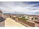 A view of the homes in the community from an outdoor patio featuring chairs and a metal fence at 6904 Baylor Creek St, North Las Vegas, NV 89086