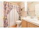 Bathroom with seashell-themed shower curtain and a clean white vanity at 7061 Roscoe Ave # 201, Las Vegas, NV 89129