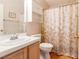 Cozy bathroom featuring a seashell themed shower curtain, a vanity with a white countertop, and built-in storage at 7061 Roscoe Ave # 201, Las Vegas, NV 89129