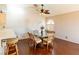 Dining room with a modern ceiling fan and hardwood floors; view into kitchen at 7061 Roscoe Ave # 201, Las Vegas, NV 89129