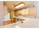 Functional kitchen featuring bright countertops and light wood cabinets, complemented by modern appliances and ample lighting at 7061 Roscoe Ave # 201, Las Vegas, NV 89129