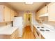 Efficient kitchen design with white appliances, light wood cabinetry, and bright countertops for a modern look at 7061 Roscoe Ave # 201, Las Vegas, NV 89129