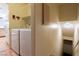 Laundry area next to the kitchen, with access to the basement stairs at 7061 Roscoe Ave # 201, Las Vegas, NV 89129