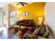 Cozy living room with wood floors, a ceiling fan, and a beautiful arched window at 7061 Roscoe Ave # 201, Las Vegas, NV 89129