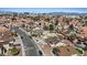 Aerial view of a suburban neighborhood showcasing diverse homes, lush trees, and community pools at 7138 Sixshooter Dr, Las Vegas, NV 89119