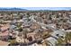 An elevated view of a backyard featuring a pool, lush landscaping, and a neighboring property with a small shed at 7138 Sixshooter Dr, Las Vegas, NV 89119