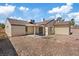 Backyard featuring patio area, desert landscaping, and neutral exterior at 7138 Sixshooter Dr, Las Vegas, NV 89119