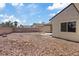 Backyard with desert landscaping, wall, and partial view of exterior at 7138 Sixshooter Dr, Las Vegas, NV 89119