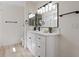 Bright bathroom with double vanity, quartz countertop, and modern black fixtures at 7138 Sixshooter Dr, Las Vegas, NV 89119