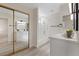 Bright, modern bathroom with a double vanity, bathtub with shower, and neutral color palette at 7138 Sixshooter Dr, Las Vegas, NV 89119