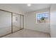 Bright bedroom features a large window and mirrored closet doors at 7138 Sixshooter Dr, Las Vegas, NV 89119
