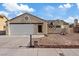 Single story stucco home with a low-pitched tile roof and two car garage at 7138 Sixshooter Dr, Las Vegas, NV 89119