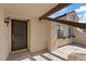 The front entry of a stucco home is adorned with an ornate security door at 7138 Sixshooter Dr, Las Vegas, NV 89119