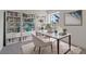 Home office with built-in bookshelves, desk, and a large window for ample natural light at 7138 Sixshooter Dr, Las Vegas, NV 89119