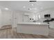 Bright kitchen featuring white cabinets, a quartz countertop island and stainless steel appliances at 7138 Sixshooter Dr, Las Vegas, NV 89119