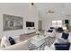 Bright, staged living room with high ceilings, white walls and luxury vinyl flooring at 7138 Sixshooter Dr, Las Vegas, NV 89119