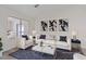 Bright, staged living room with comfortable seating and modern decor at 7138 Sixshooter Dr, Las Vegas, NV 89119