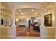 View of living and dining rooms with hardwood floors, chandelier, and neutral color palette at 7325 Rustic Crest St, Las Vegas, NV 89149