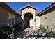 Close up view of the front door and landscaping, with brick walkway and metalwork at 7325 Rustic Crest St, Las Vegas, NV 89149