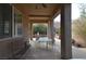 Spacious covered patio with a seating area and views of the landscaped backyard at 7325 Rustic Crest St, Las Vegas, NV 89149