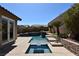 Backyard featuring a modern pool, stepped stone features, with mature landscaping at 7325 Rustic Crest St, Las Vegas, NV 89149