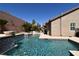 Sparkling pool with elegant water feature, lush landscaping, and privacy wall at 7325 Rustic Crest St, Las Vegas, NV 89149