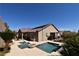 Backyard features a refreshing pool with custom waterfall and desert landscaping at 7325 Rustic Crest St, Las Vegas, NV 89149