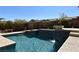 Beautiful pool area featuring sparkling blue water and a stone waterfall feature, perfect for relaxation at 7325 Rustic Crest St, Las Vegas, NV 89149