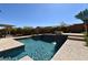 Stunning outdoor pool area complete with waterfall feature, bench seating, and lush greenery at 7325 Rustic Crest St, Las Vegas, NV 89149