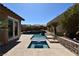 Backyard oasis featuring a pool and integrated spa with a tiered waterfall, surrounded by lush landscaping at 7325 Rustic Crest St, Las Vegas, NV 89149