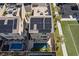 Aerial view of the modern home, rooftop deck, solar panels, and a luxurious swimming pool at 8116 Haywood Estate Ave, Las Vegas, NV 89113