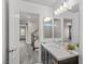 Bathroom view showcases modern finishes, with a gray wood floors and open doorway at 8116 Haywood Estate Ave, Las Vegas, NV 89113