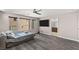 Bedroom features a bed, TV, wood floors and three windows at 8116 Haywood Estate Ave, Las Vegas, NV 89113