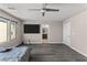Bedroom features a TV, wood floors, windows and an ensuite bathroom at 8116 Haywood Estate Ave, Las Vegas, NV 89113