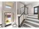 Bright home entry showcasing stairs with modern railing and access to garage at 8116 Haywood Estate Ave, Las Vegas, NV 89113