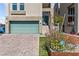 Close up view of charming home featuring brick paver driveway and manicured front yard at 8116 Haywood Estate Ave, Las Vegas, NV 89113
