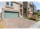 Modern home featuring an attached garage, brick paver driveway, and manicured front yard at 8116 Haywood Estate Ave, Las Vegas, NV 89113