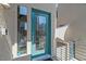 Modern home entrance with a teal door, large window, and security camera at 8116 Haywood Estate Ave, Las Vegas, NV 89113