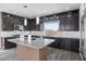 Stylish kitchen boasts stainless steel appliances, a granite island, and ample counter space at 8116 Haywood Estate Ave, Las Vegas, NV 89113
