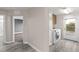 Convenient laundry room featuring modern washer and dryer, ample storage, and access to the backyard at 8116 Haywood Estate Ave, Las Vegas, NV 89113
